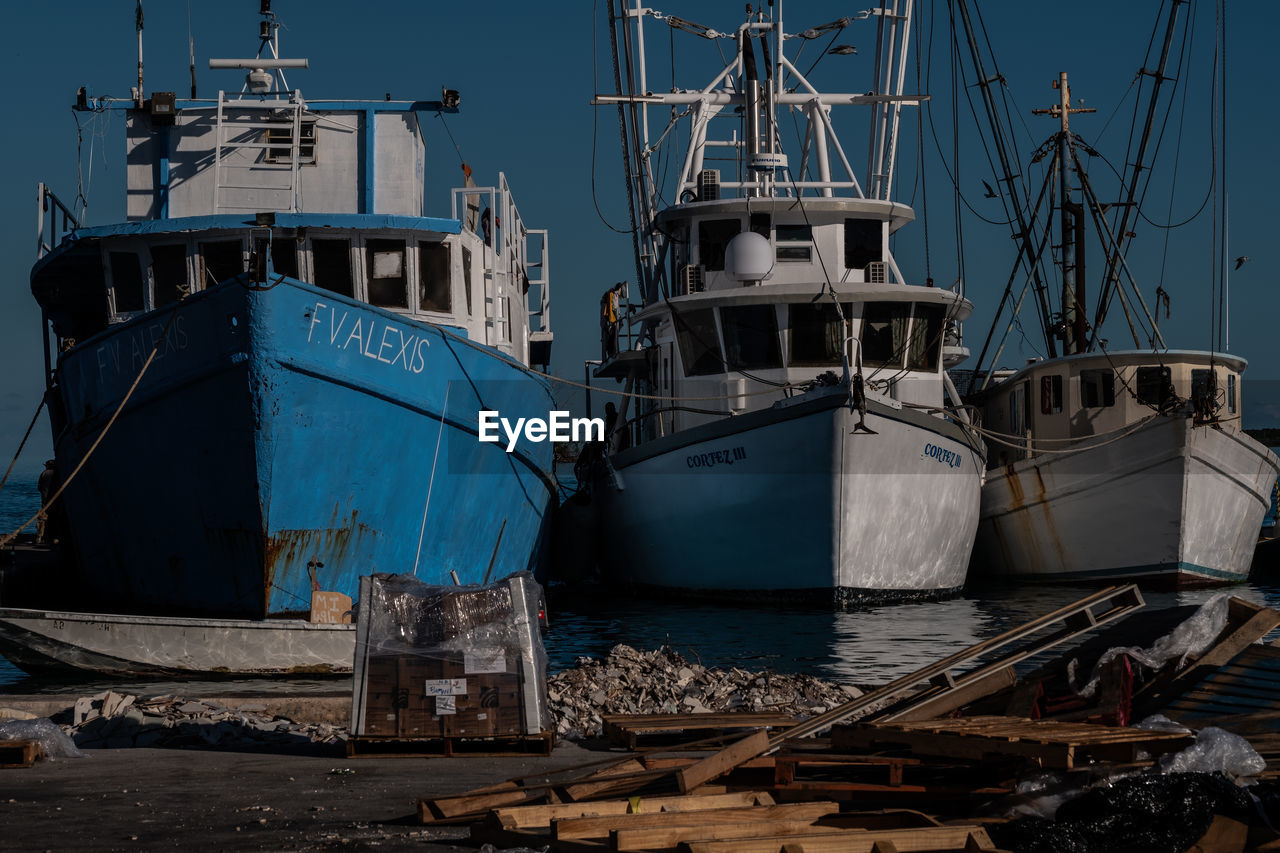 FISHING BOATS MOORED AT HARBOR