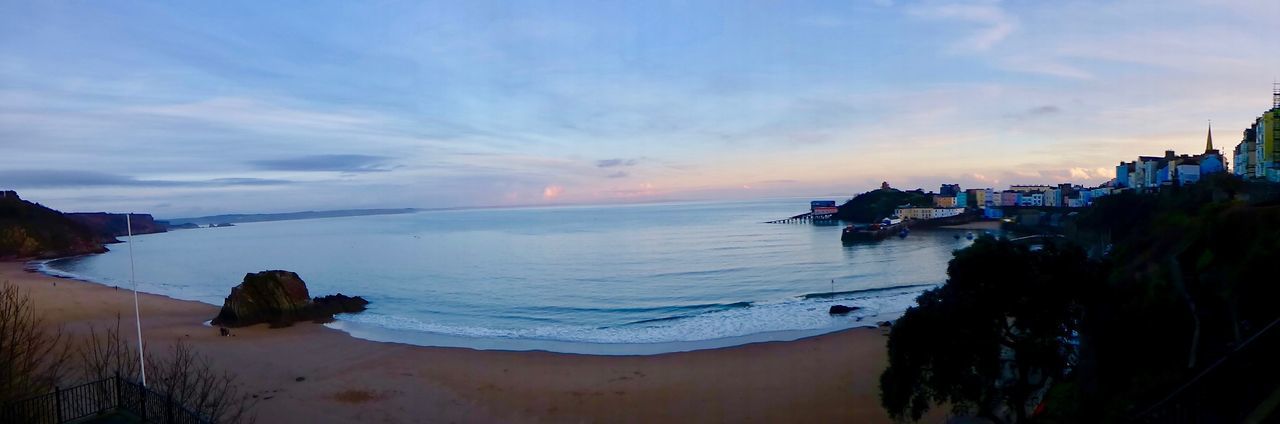 VIEW OF CALM BEACH AGAINST SKY