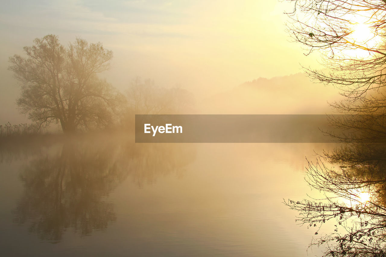 Scenic view of lake against sky during sunset