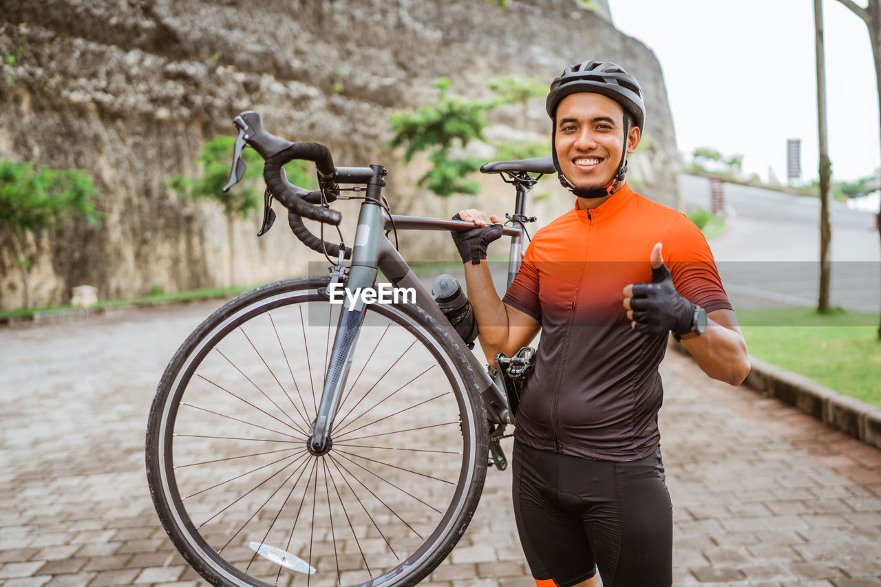 portrait of smiling man riding bicycle