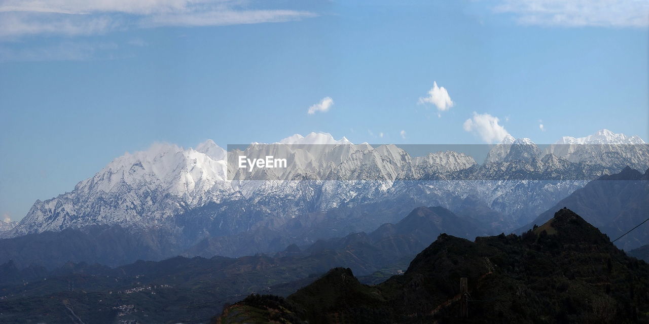 Panoramic view of snowcapped mountains against sky