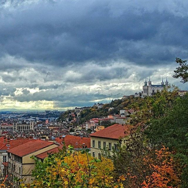 HOUSES AGAINST CLOUDY SKY