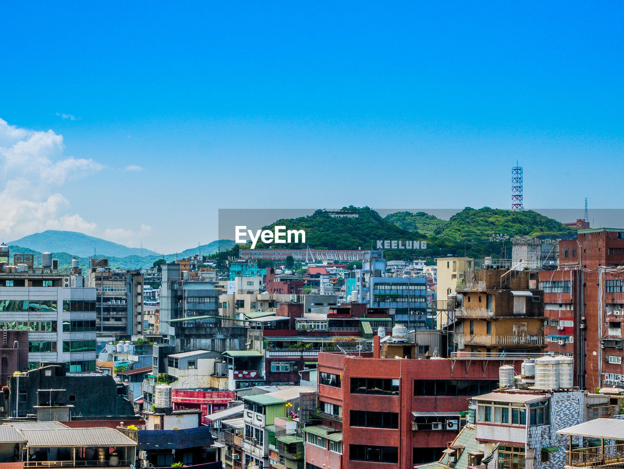 High angle view of buildings against blue sky