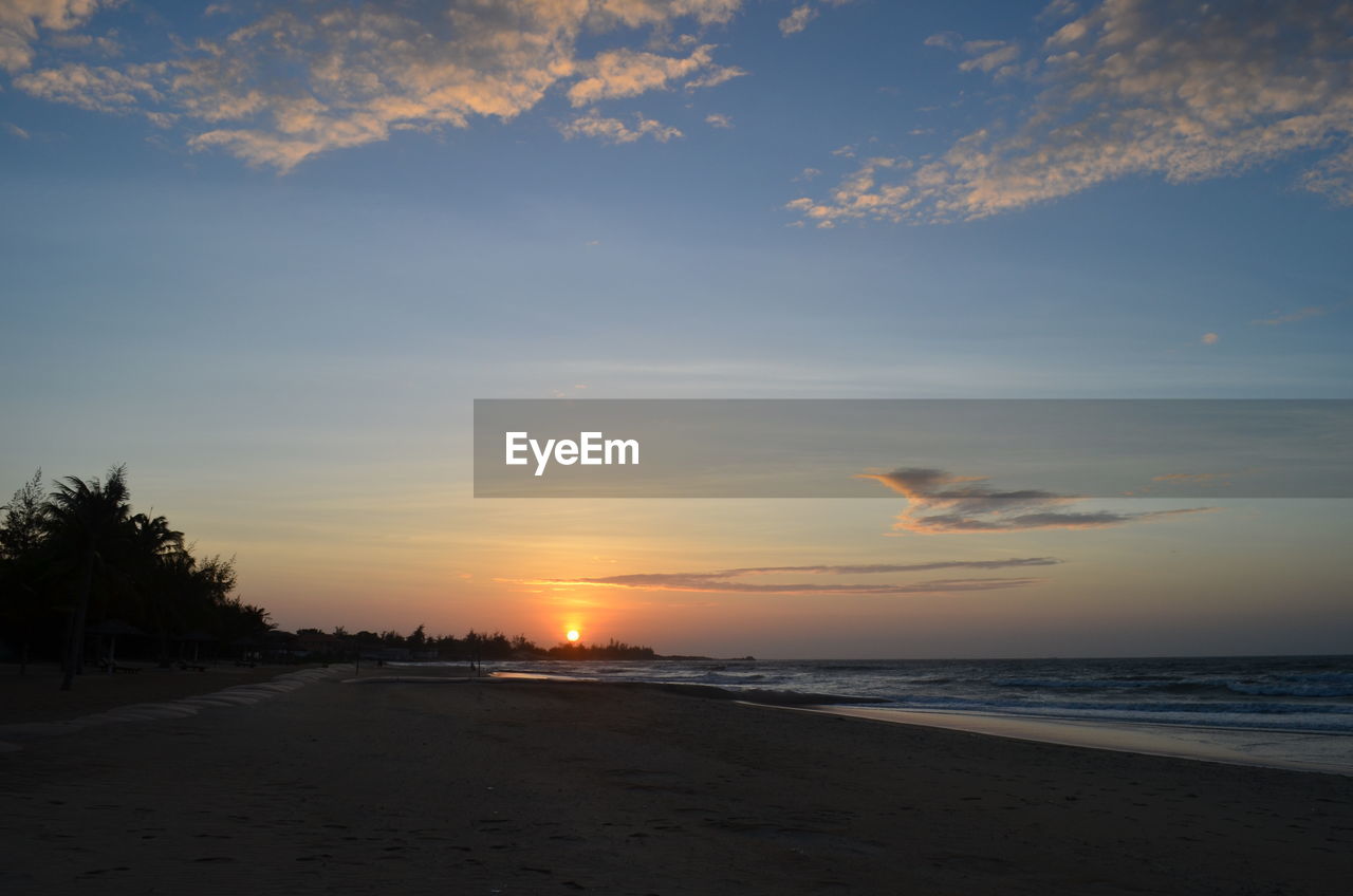 SCENIC VIEW OF BEACH DURING SUNSET