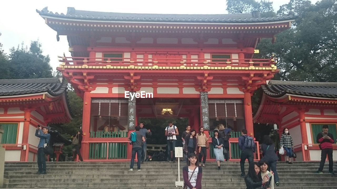 GROUP OF PEOPLE AT TEMPLE