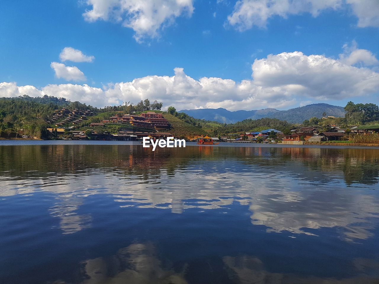 SCENIC VIEW OF LAKE BY BUILDING AGAINST SKY