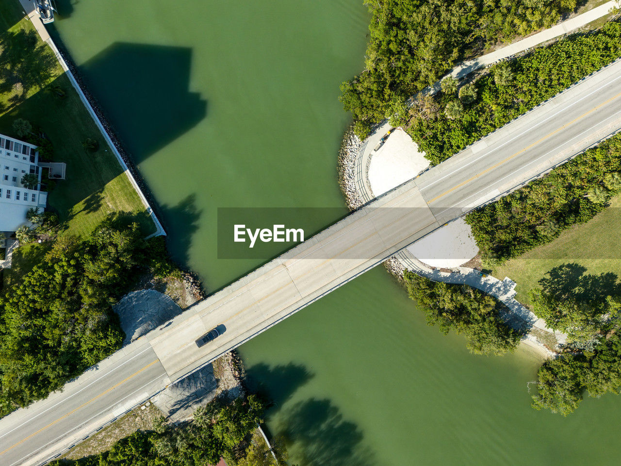 aerial photography, water, plant, nature, aerial view, high angle view, tree, green, no people, environment, day, lake, architecture, outdoors, transportation, built structure, sunlight, land, bird's-eye view, travel, bridge, landscape, environmental conservation