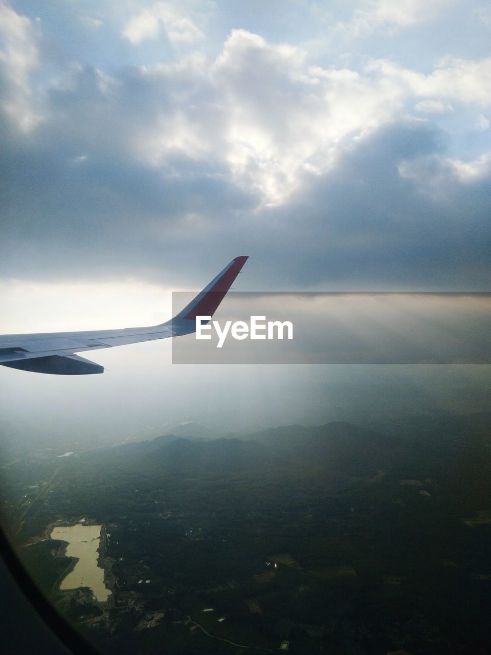 AIRPLANE FLYING OVER LANDSCAPE