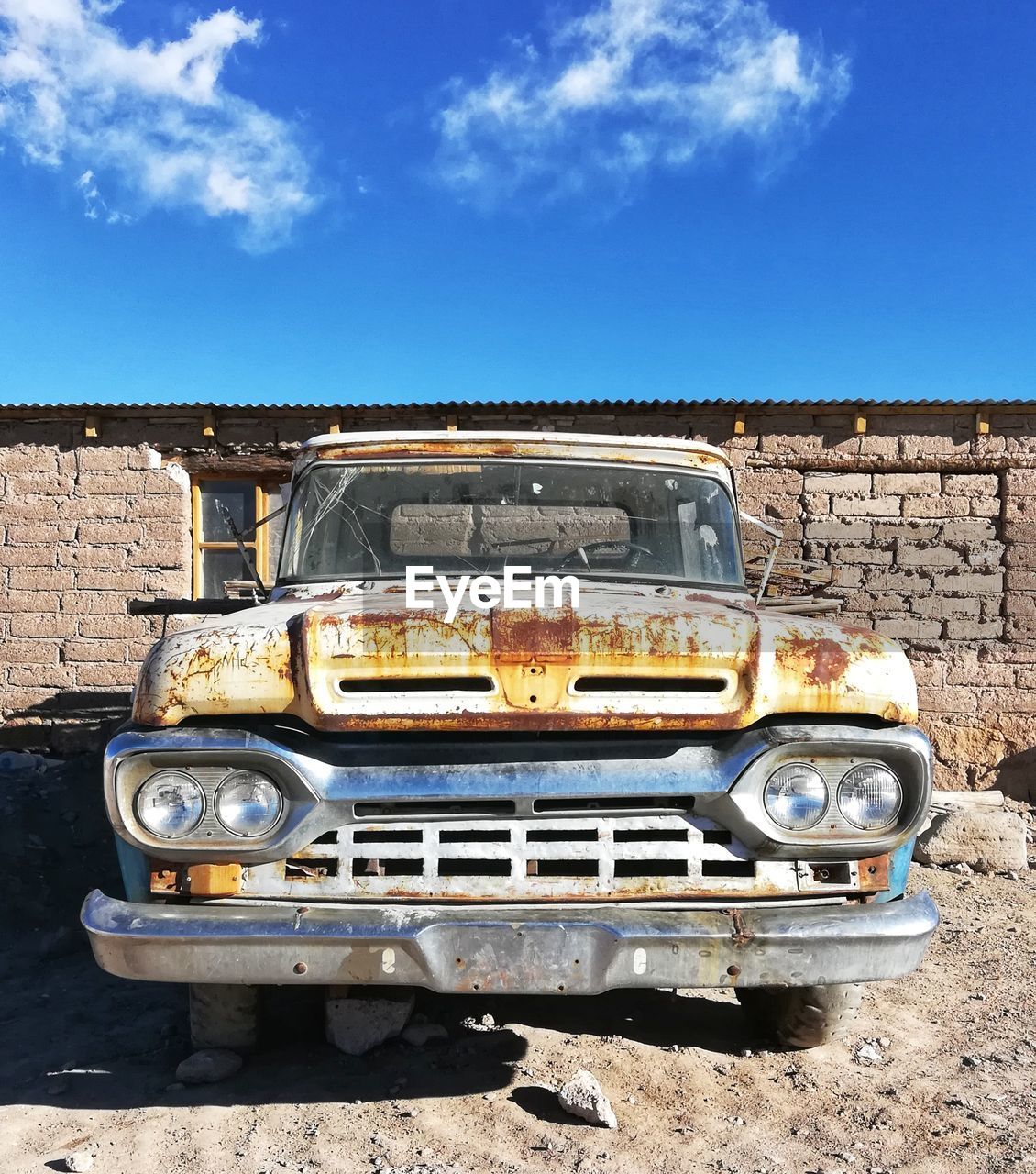 Abandoned car against sky