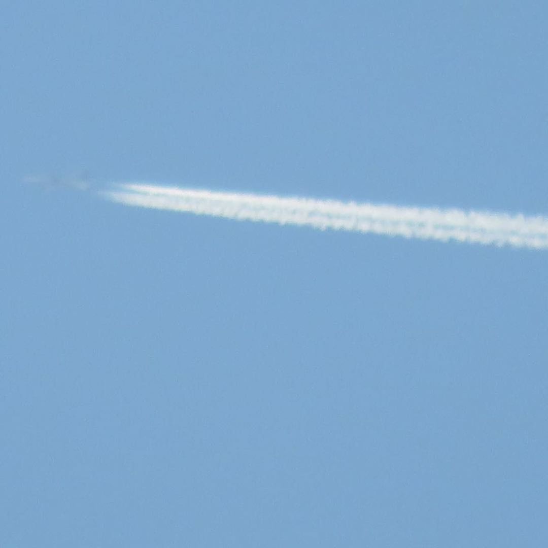 VAPOR TRAIL AGAINST BLUE SKY