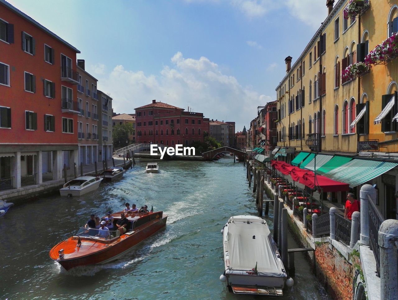 BOATS MOORED IN CANAL ALONG BUILDINGS