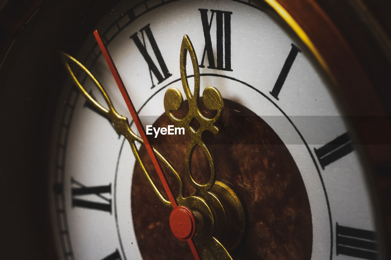 Close-up of clock against wall at night