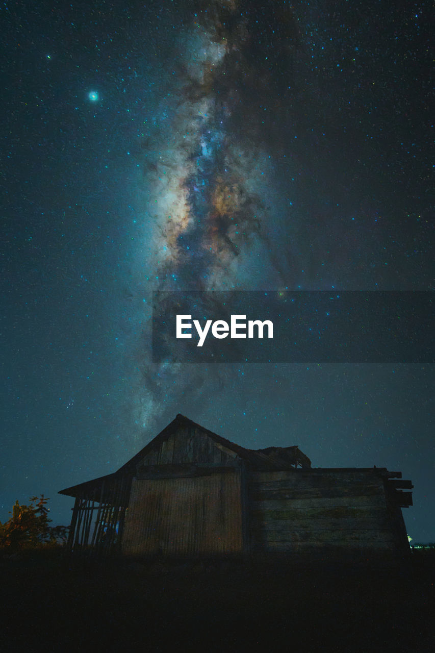 Low angle view of abandoned building against sky at night