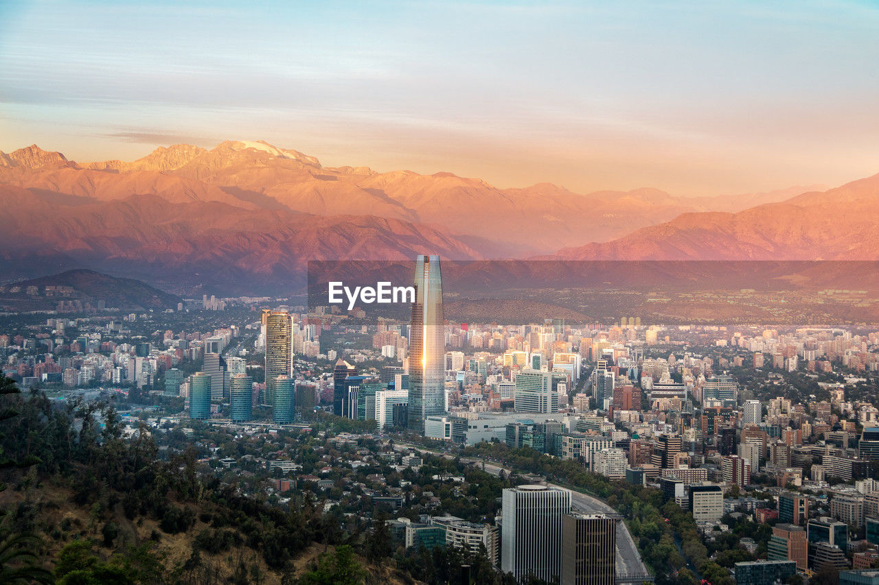 high angle view of city against sky during sunset