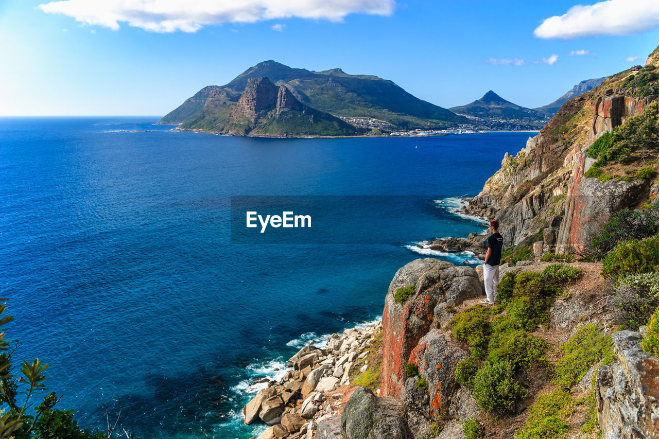 Scenic view of sea and mountains against sky