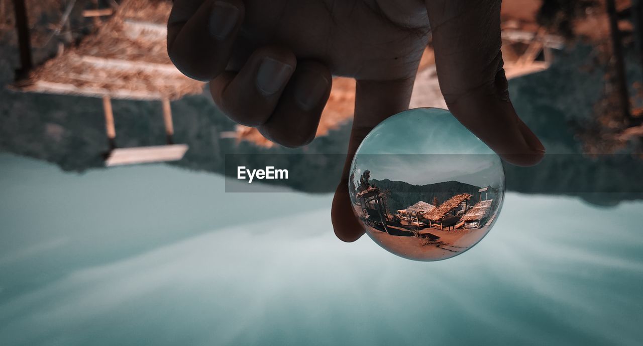 Upside down image of person holding crystal ball