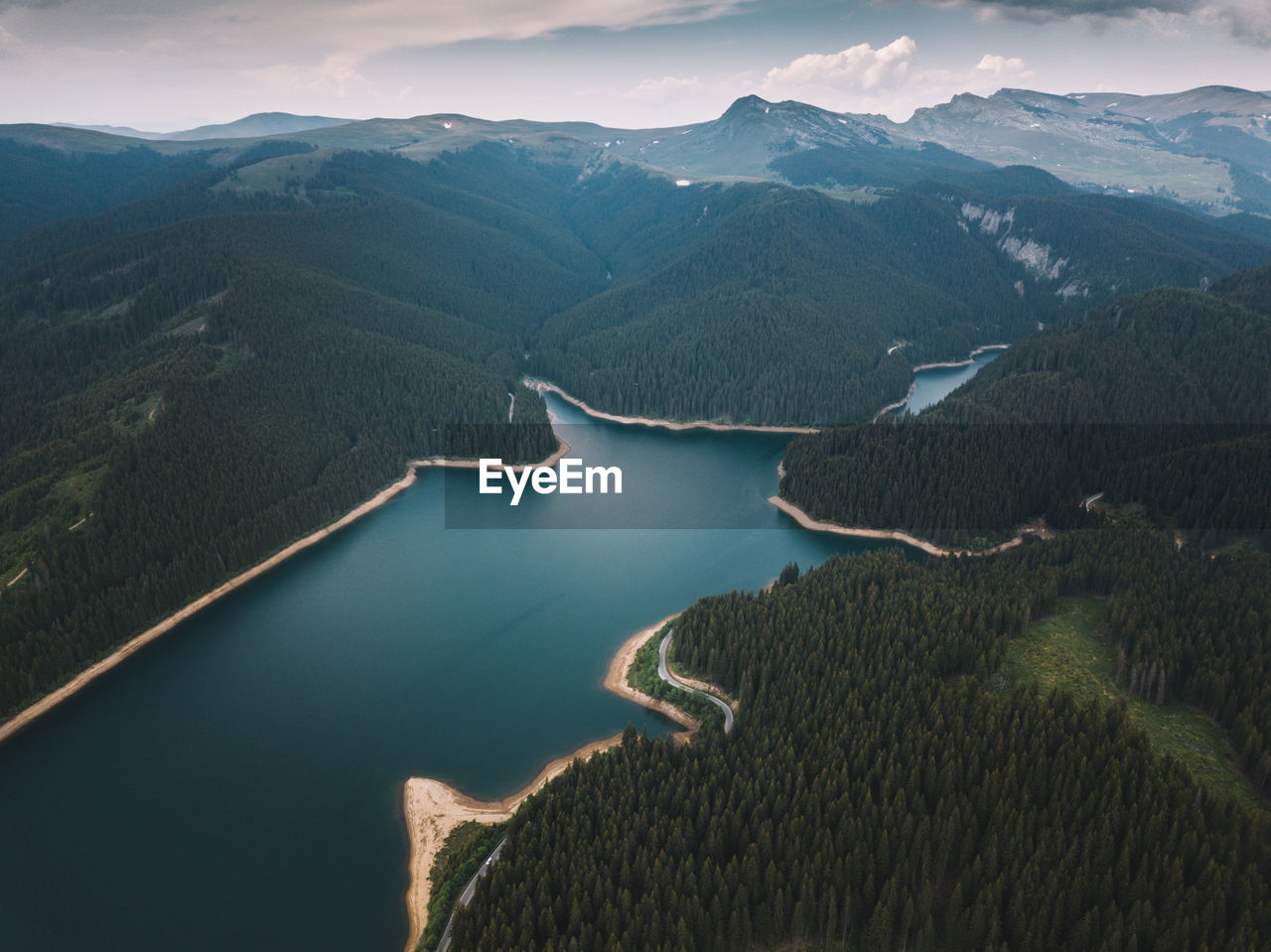 Aerial view of lake and mountains against sky