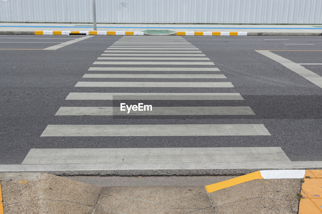 Line of crosswalk way across road in bangkok, thailand