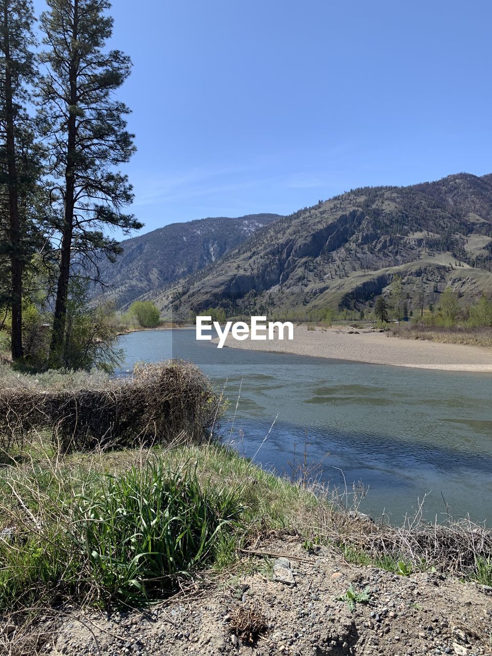 Scenic view of lake and mountains against clear sky