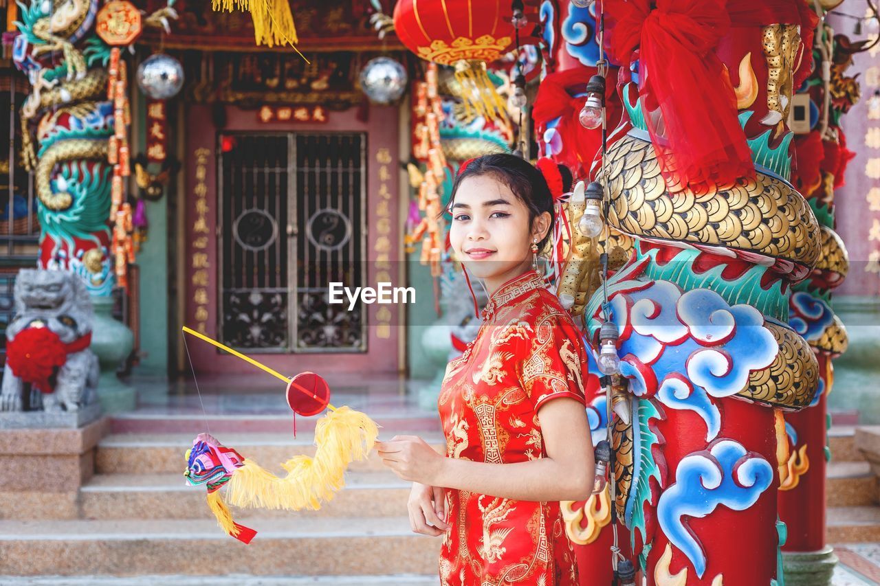 Portrait of girl standing against temple