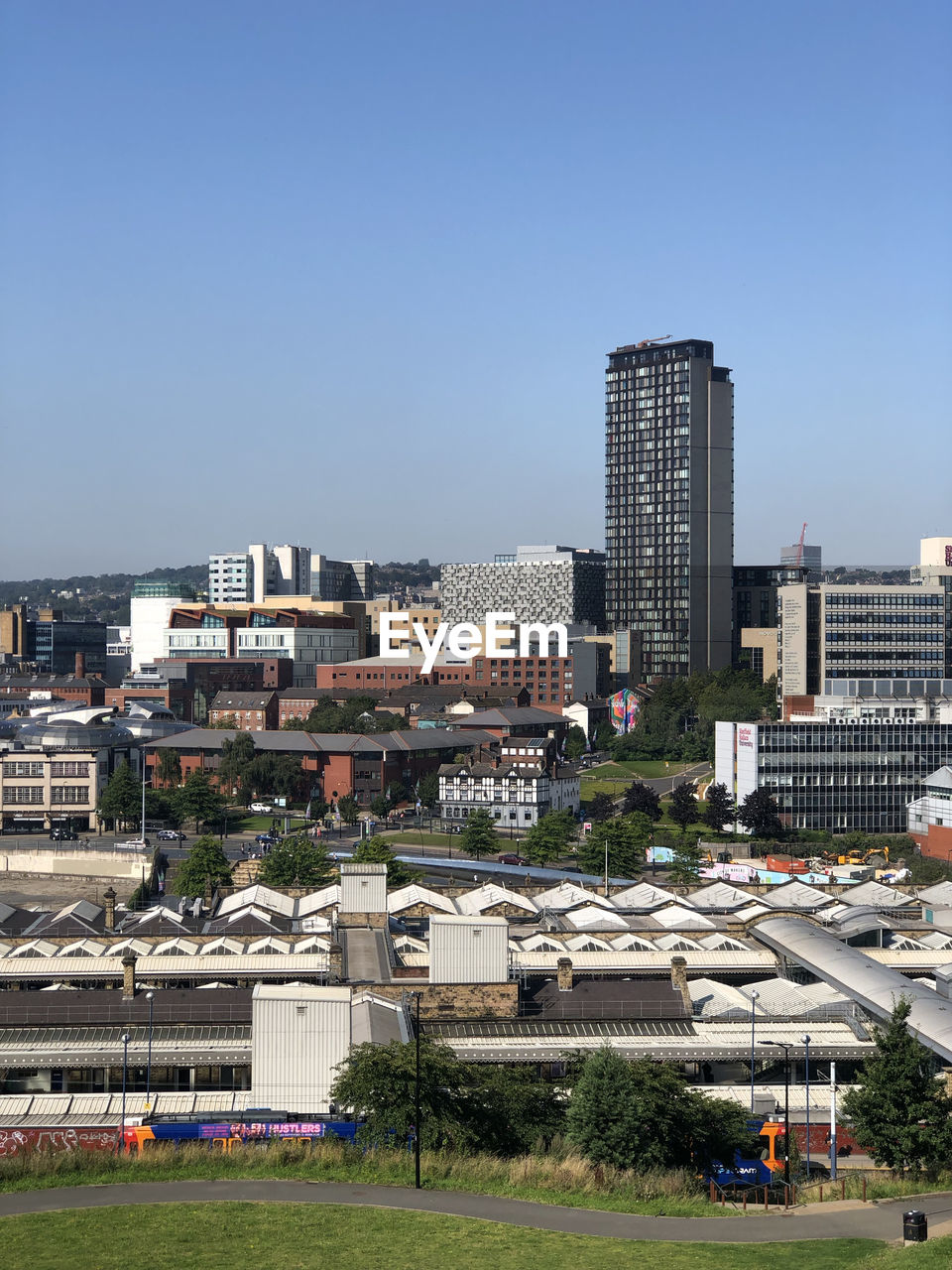 Buildings in city against clear sky