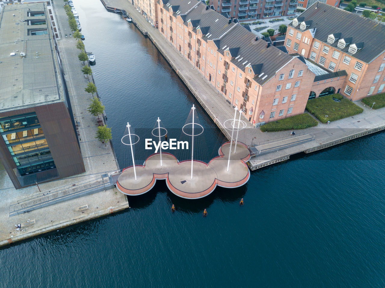 HIGH ANGLE VIEW OF BUILDINGS BY RIVER