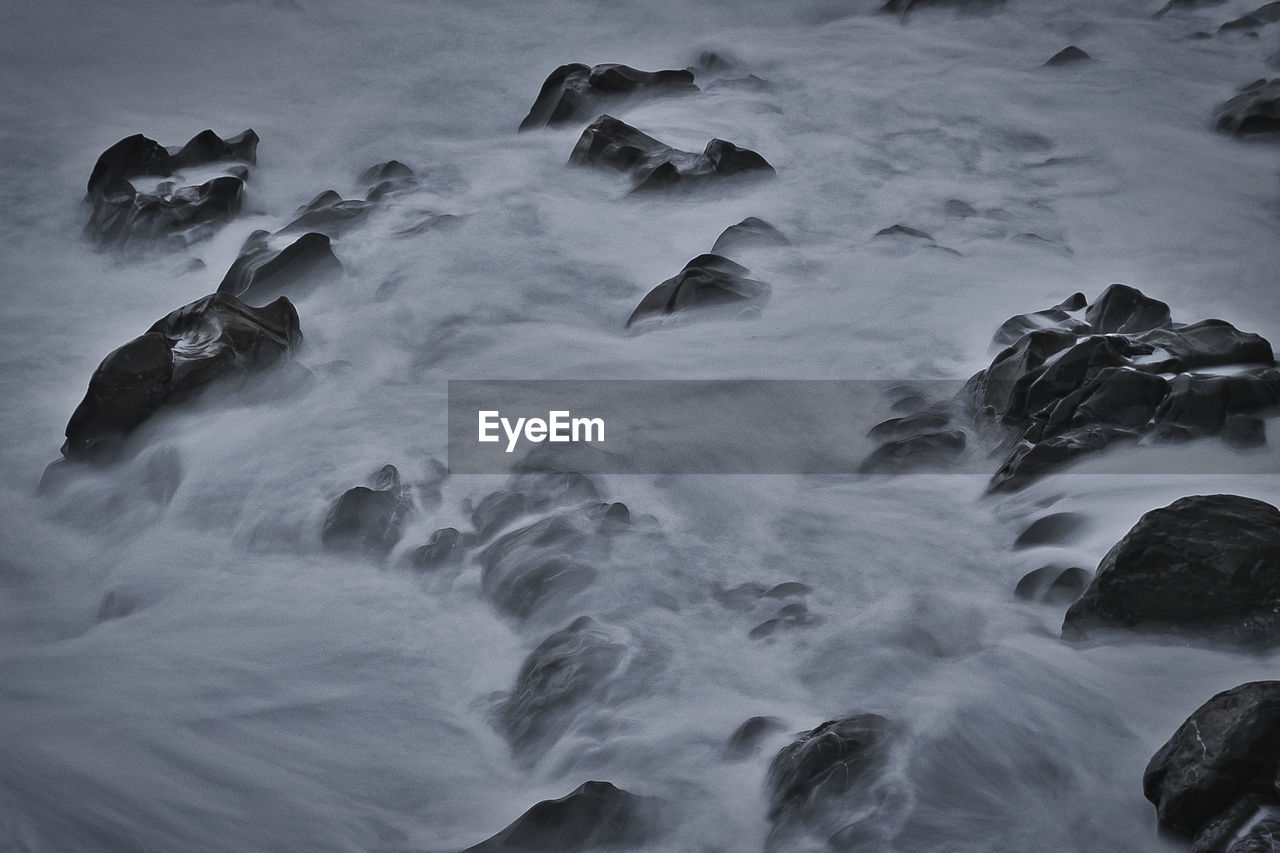 Blurred motion of rocks in sea