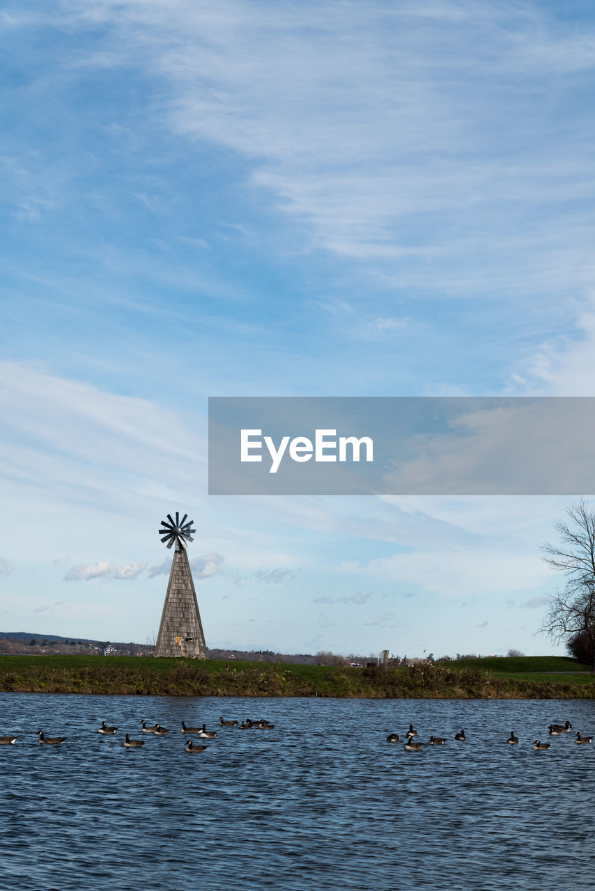 water, sky, sea, shore, cloud, nature, architecture, tower, built structure, no people, day, horizon, reflection, coast, waterfront, ocean, lighthouse, beauty in nature, outdoors, scenics - nature, bay, travel destinations, plant, tranquility, environment, travel, tranquil scene, building exterior, blue, windmill, building