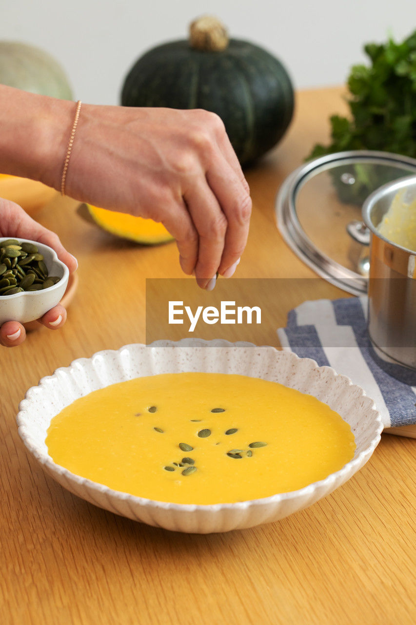 cropped hands of woman holding food on table