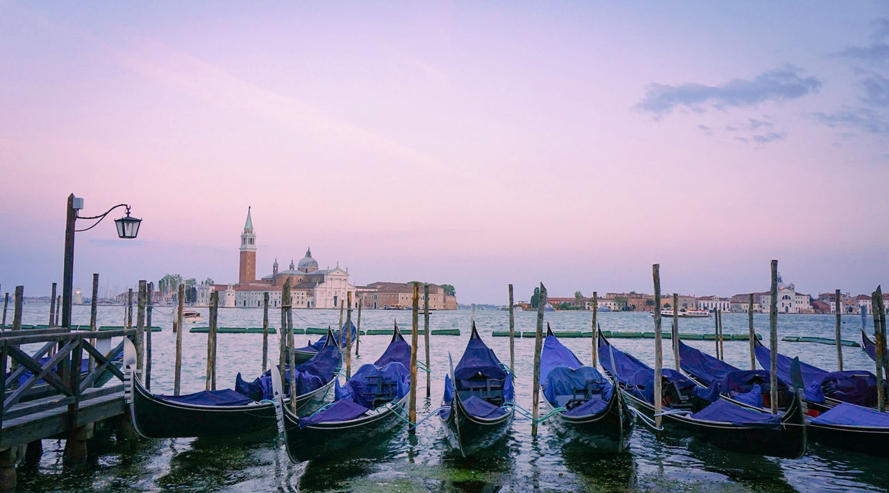 Gondolas moored on grand canal against clear sky