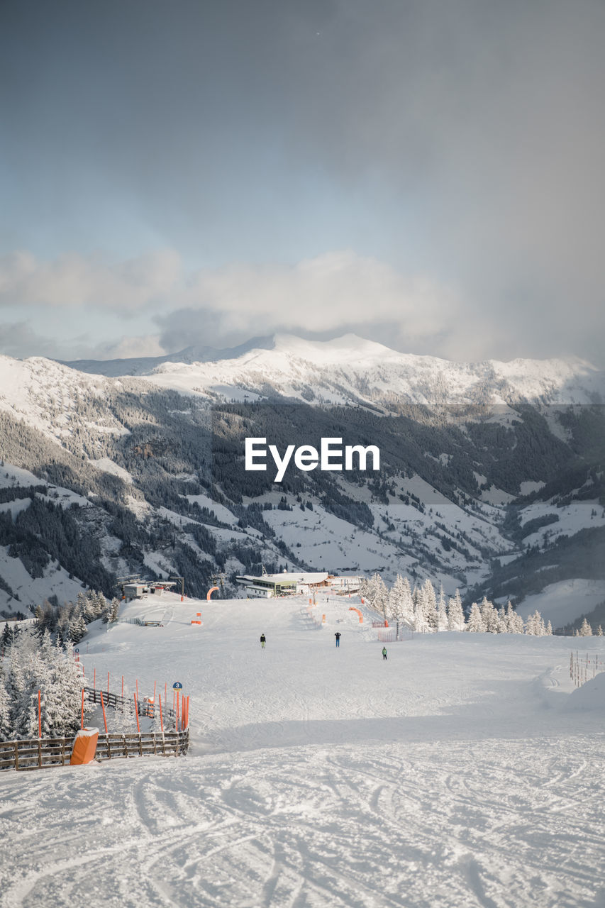 Skiers on empty slopes during covid-19 pandemic in the austrian alps.