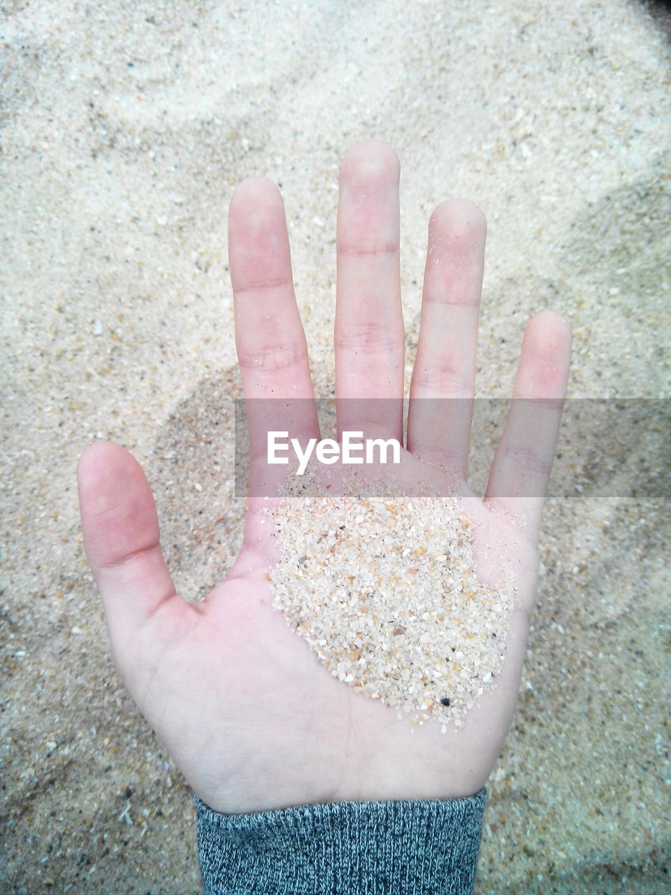 Human hand holding sand