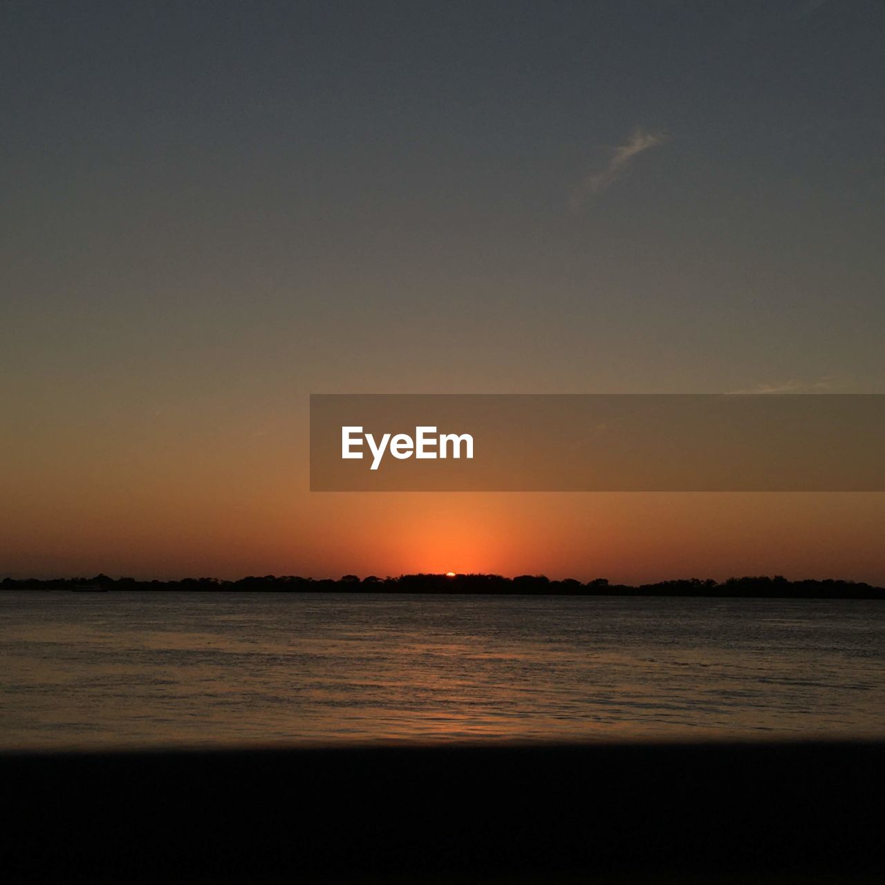 SCENIC VIEW OF BEACH AGAINST SKY DURING SUNSET