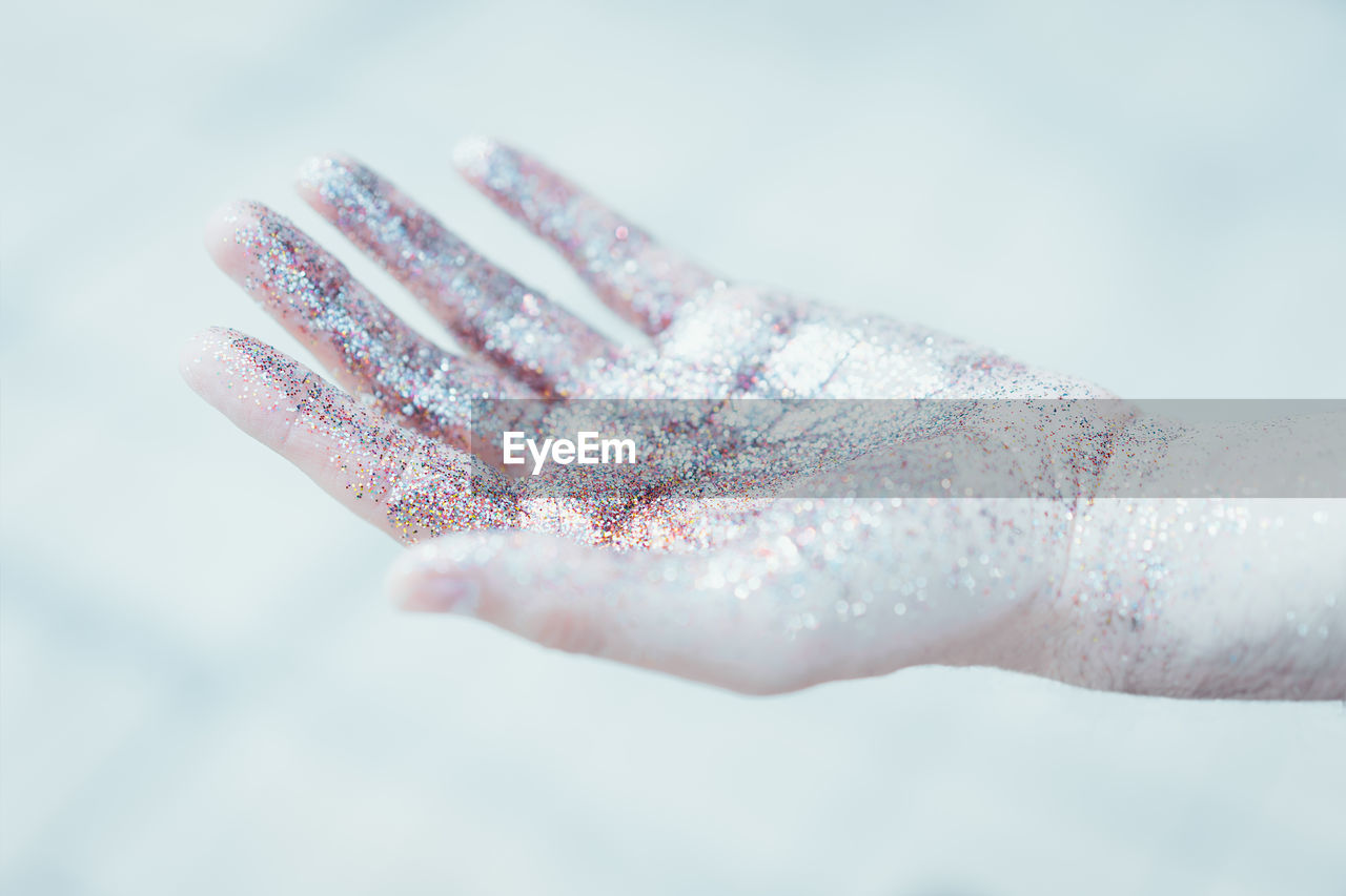 Close-up of hand against white background