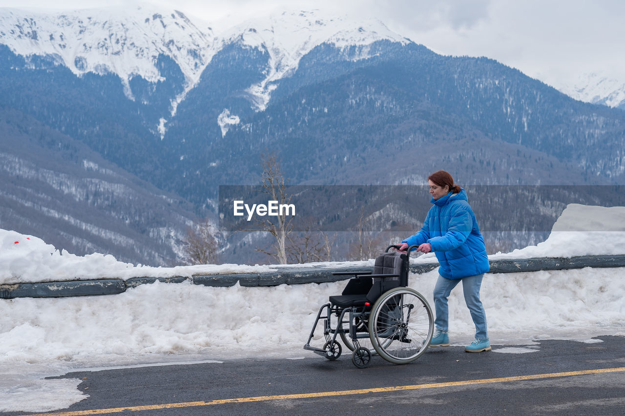 rear view of man skiing on snow covered mountain