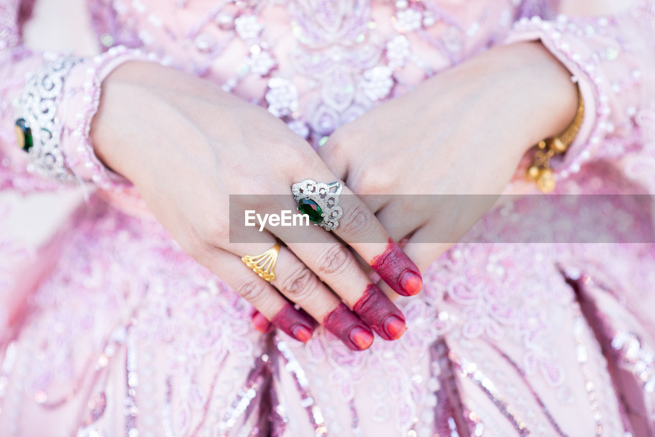 Midsection of bride wearing rings