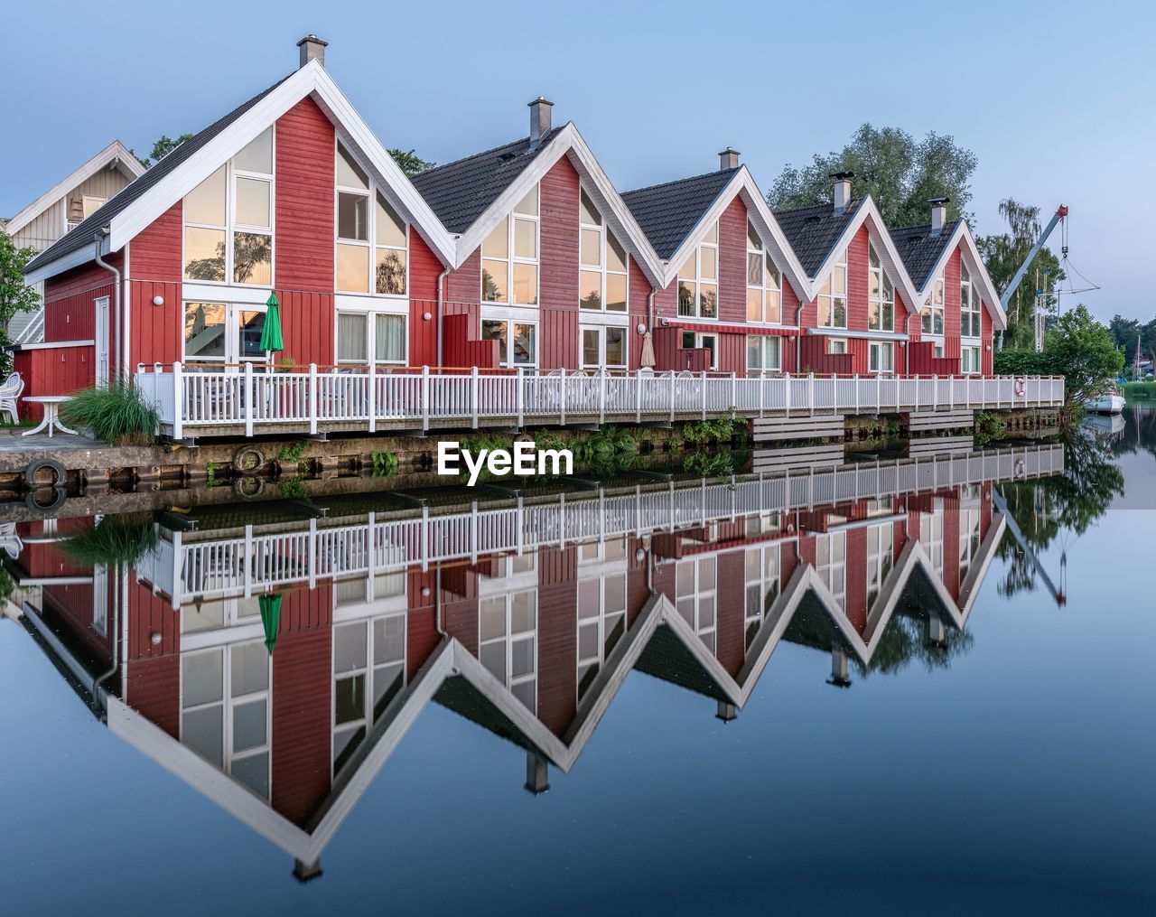 architecture, built structure, water, building exterior, building, house, reflection, residential district, nature, sky, city, no people, home ownership, blue, outdoors, row house, lake, multi colored, in a row