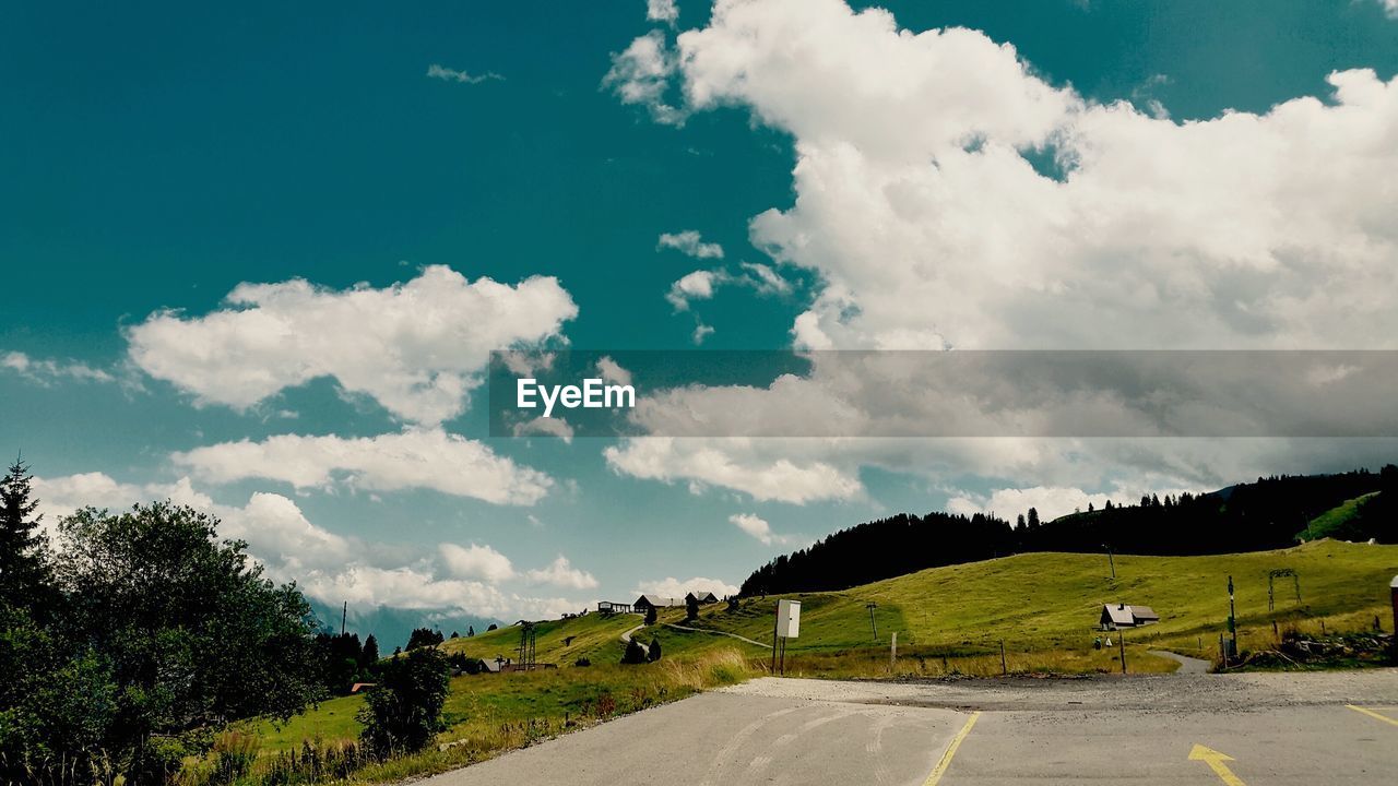 Mountain road against cloudy sky