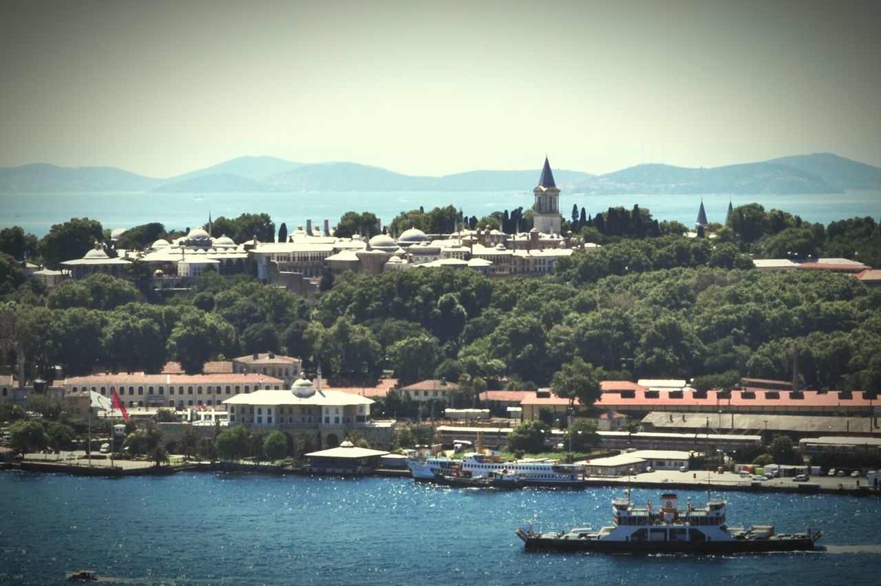 High angle view of historic buildings by river against sky