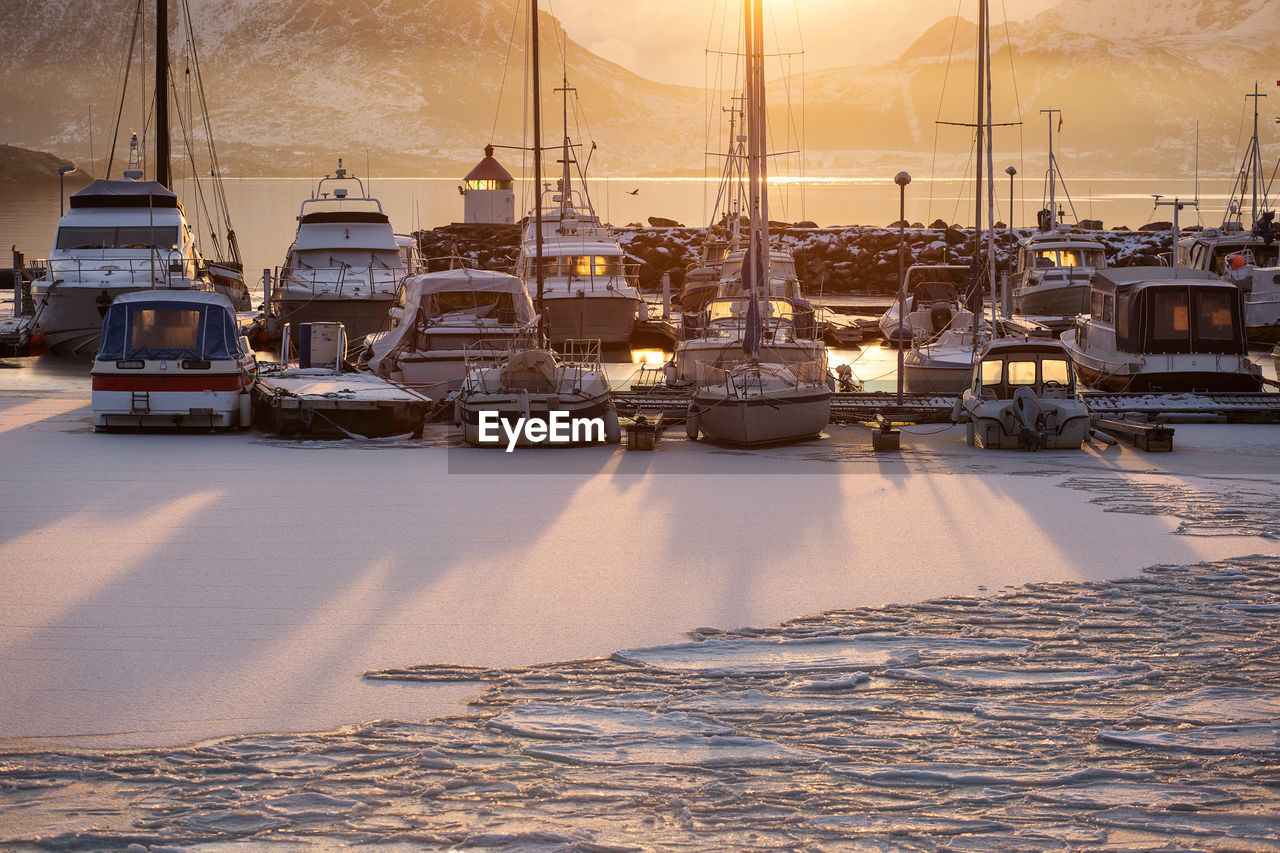 Boats moored at harbor during winter