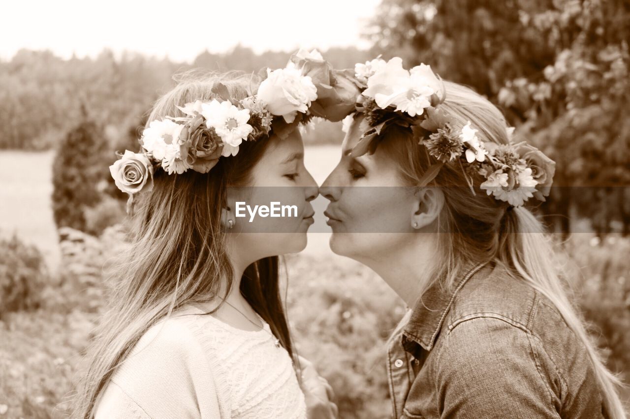 PORTRAIT OF A BEAUTIFUL YOUNG WOMAN WITH FLOWERS
