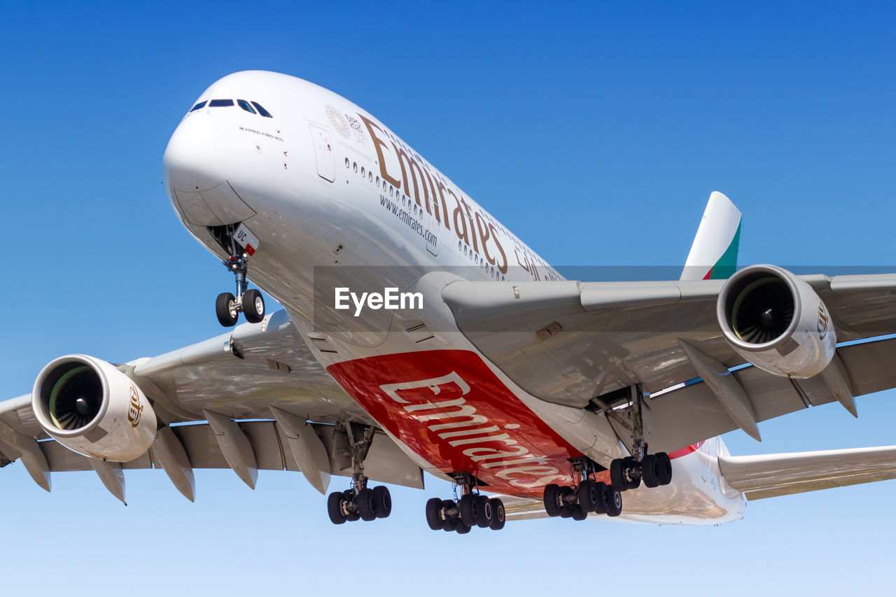 LOW ANGLE VIEW OF AIRPLANE AGAINST CLEAR SKY