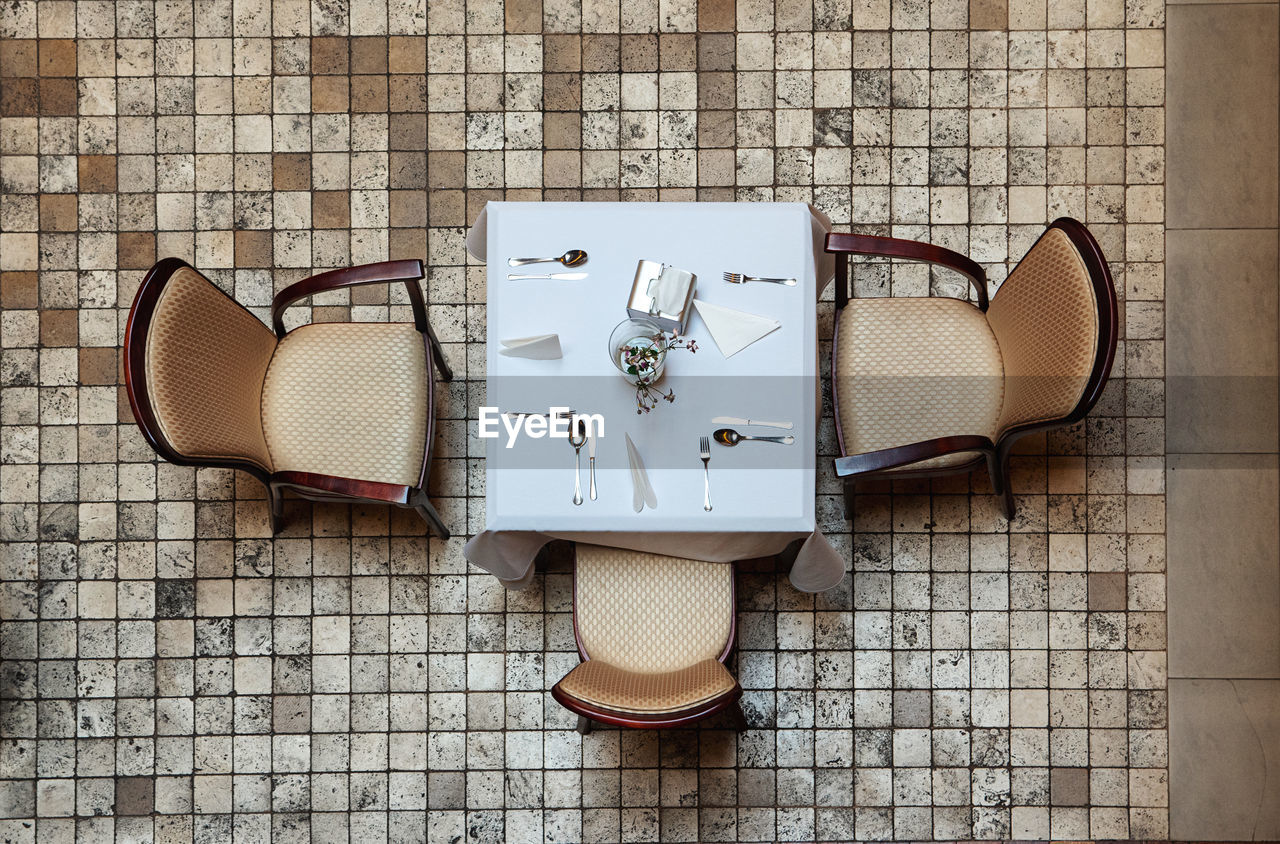 High angle view of table and three chairs