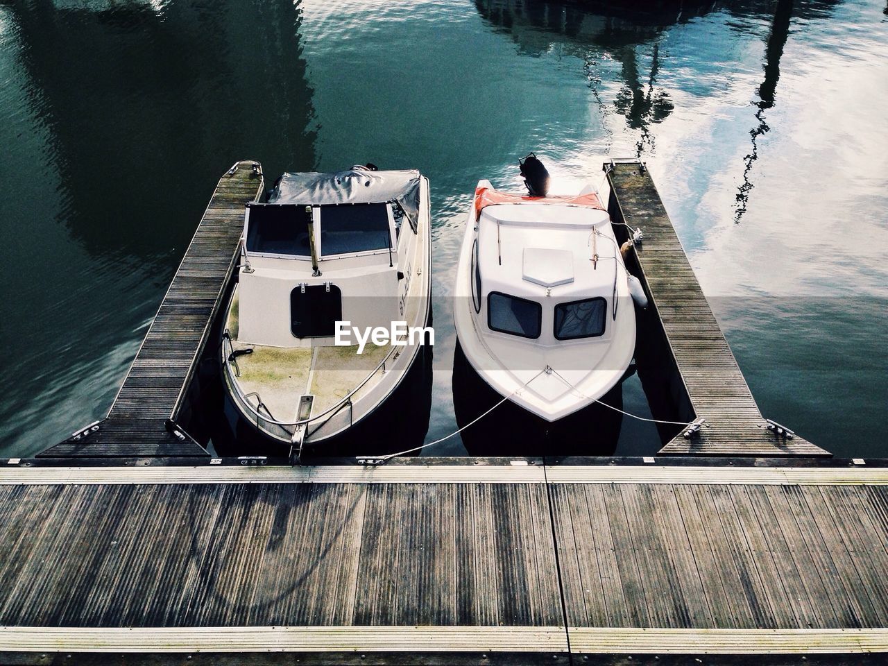 High angle view of small yachts moored at pier