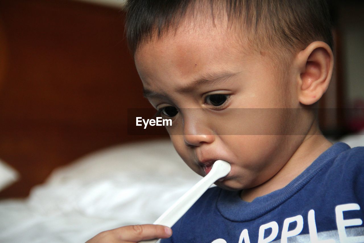 Close-up of cute boy brushing teeth