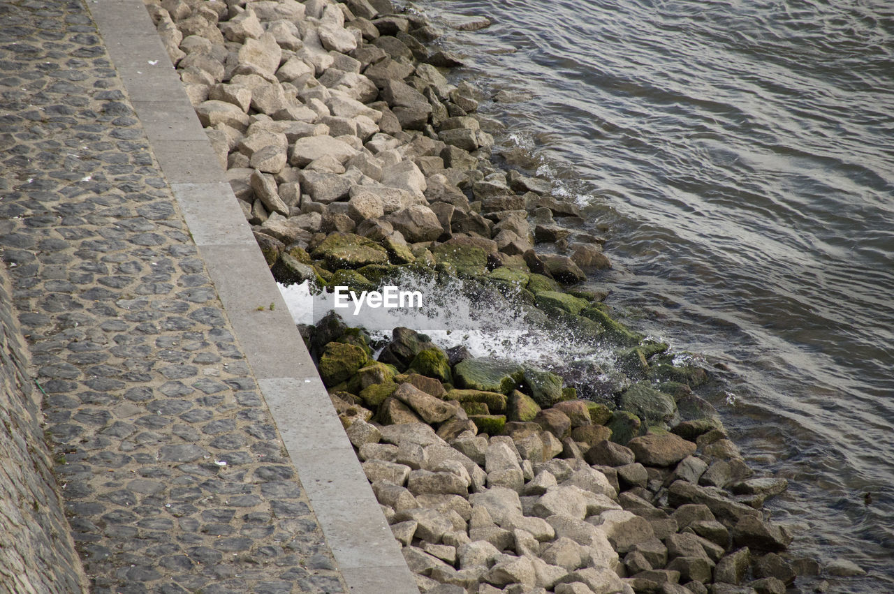 High angle view of pebbles in water