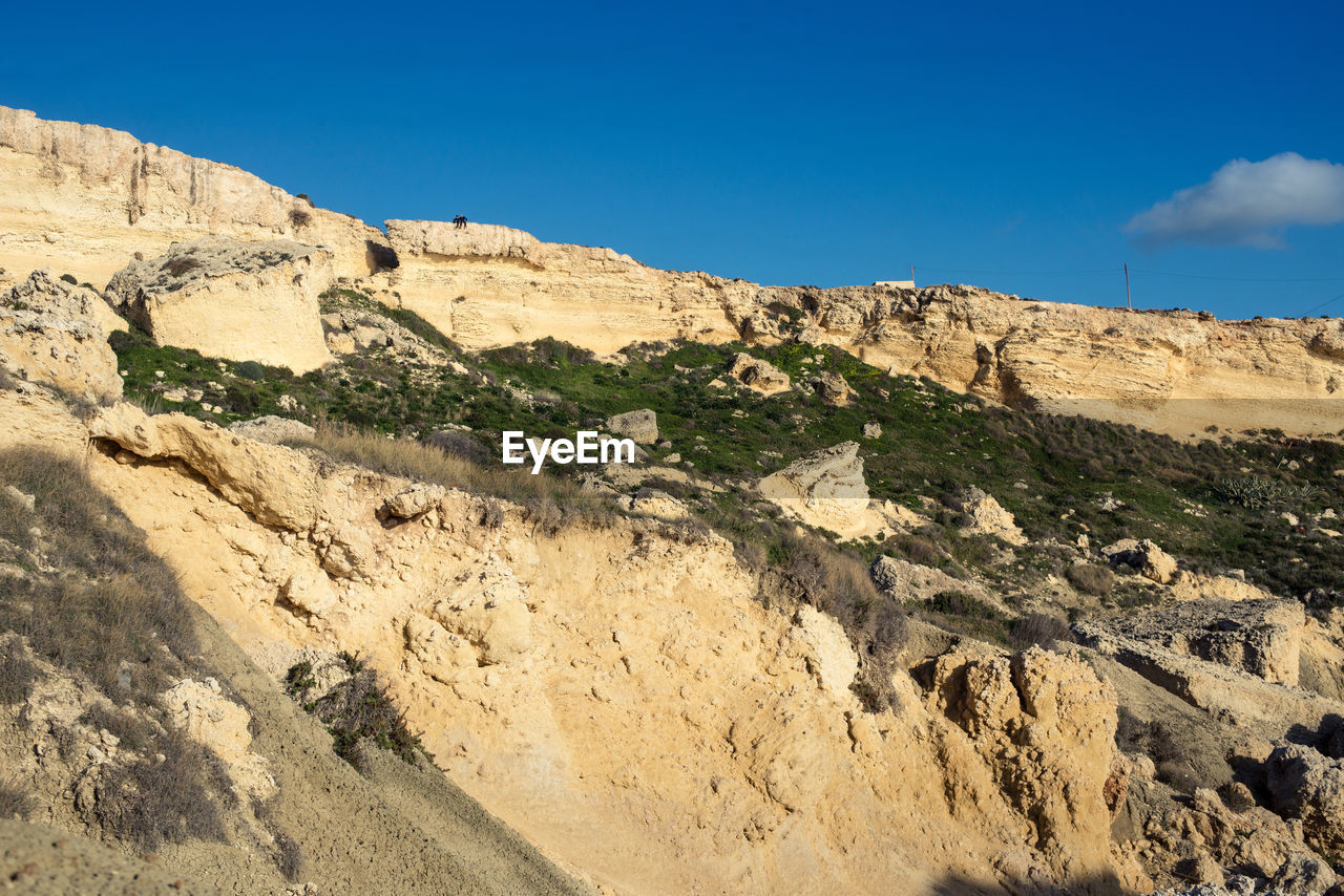 Scenic view of landscape against blue sky