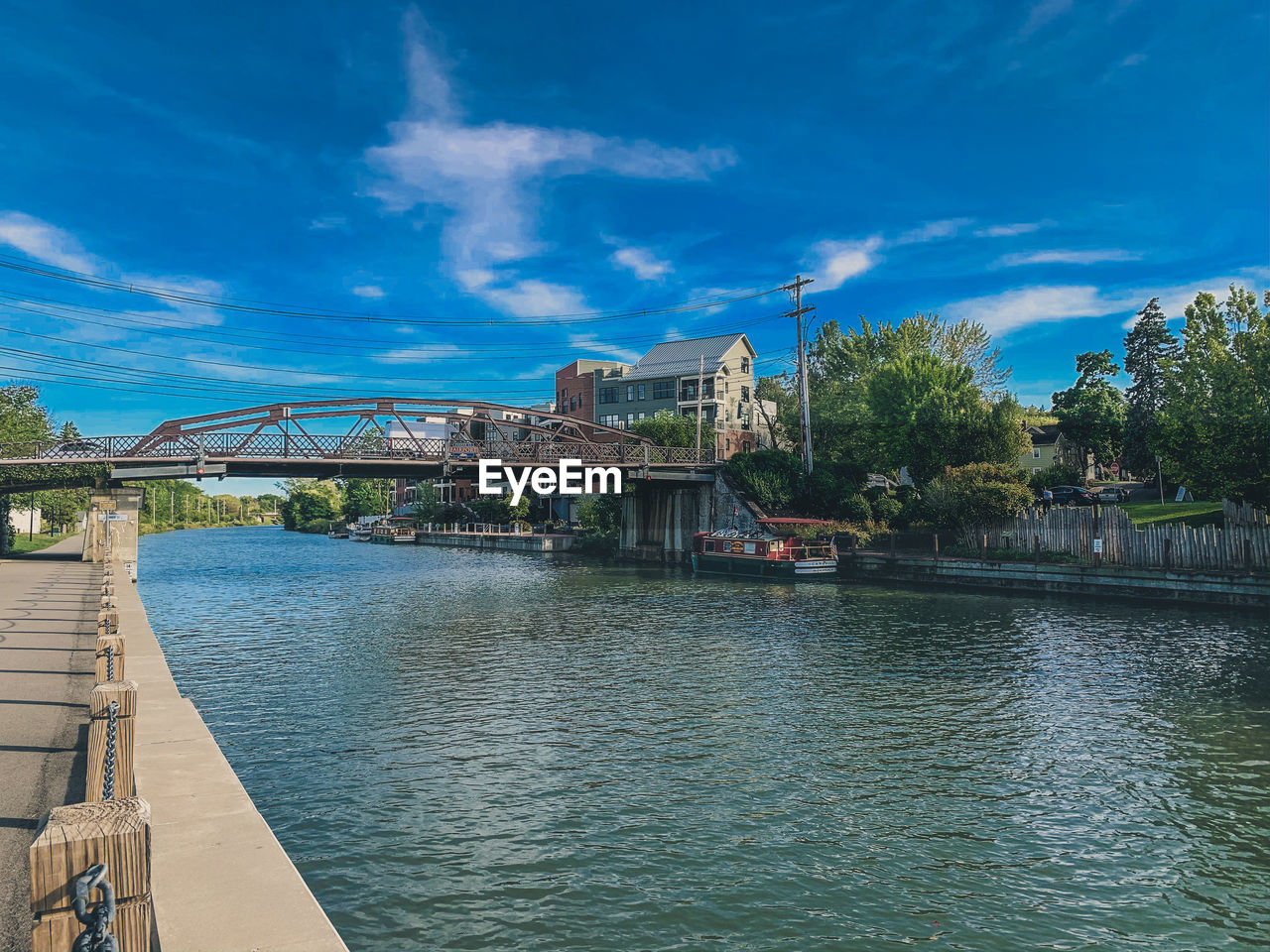 Bridge over river against sky in city