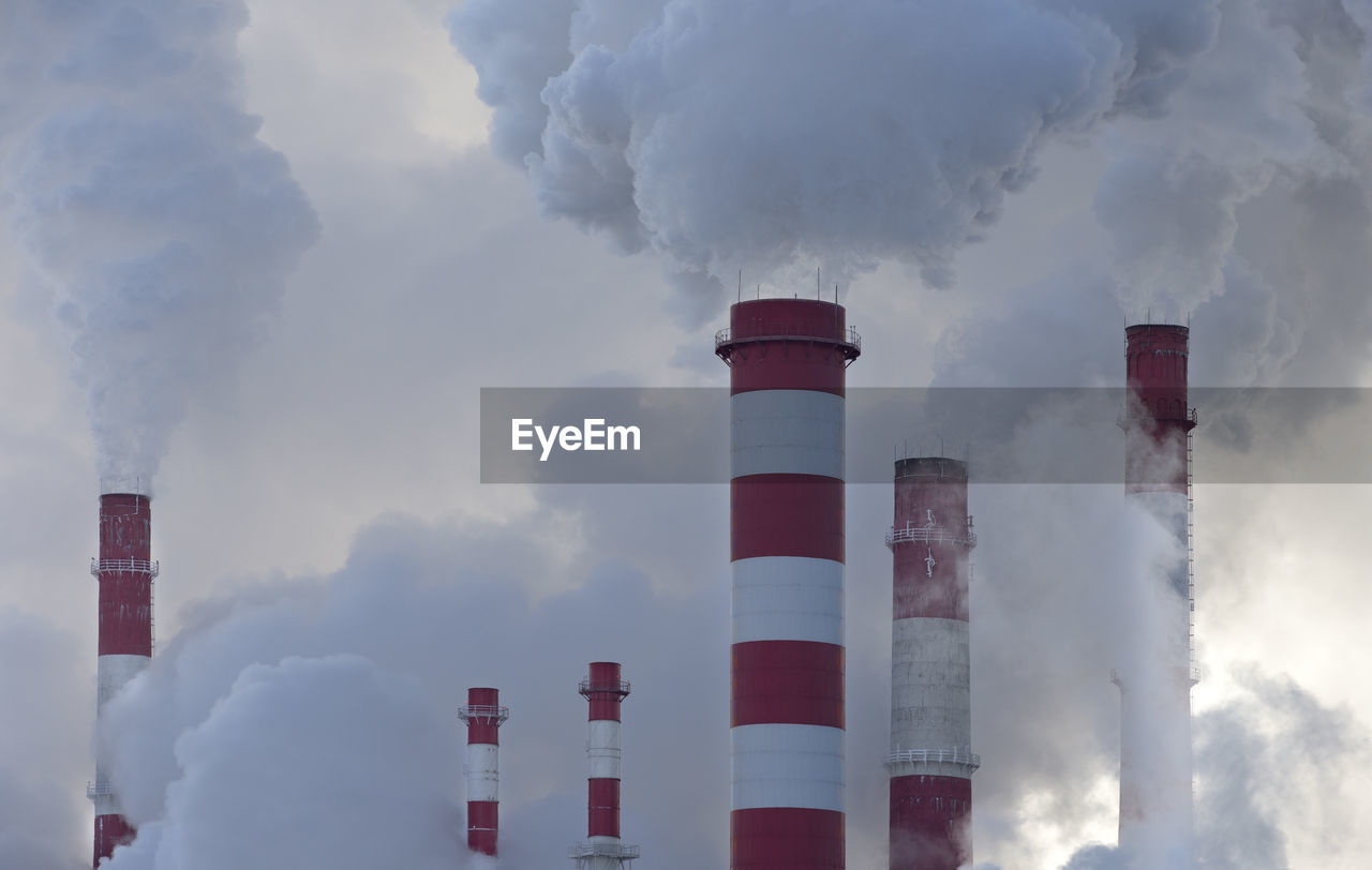 Panoramic view of smoke stack against sky