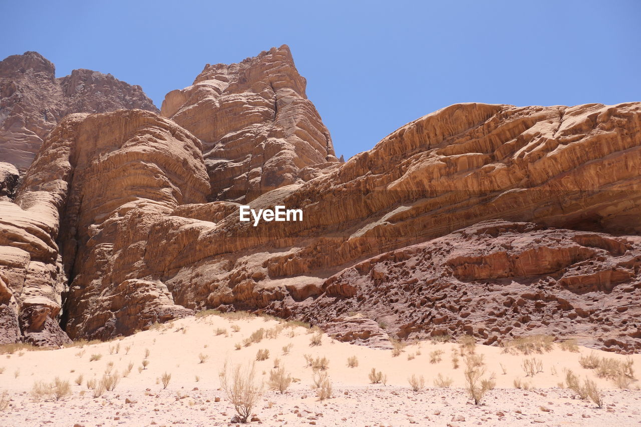 Rock formations in wadi rum on landscape against clear sky